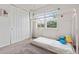 Bright bedroom with a twin bed, window with lots of natural light, and a closet at 7410 S Old Hammer Way, Aurora, CO 80016