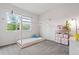 Bright bedroom with a twin bed, window with lots of natural light, and decor at 7410 S Old Hammer Way, Aurora, CO 80016