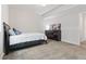 Bedroom featuring a large bed, dresser, and artwork adding a modern touch at 7410 S Old Hammer Way, Aurora, CO 80016