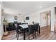 Inviting dining area with stylish table set, modern light fixture, and seamless flow into the living space at 7410 S Old Hammer Way, Aurora, CO 80016