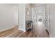 Bright hallway with hardwood floors leading to a dining area and multiple rooms at 7410 S Old Hammer Way, Aurora, CO 80016