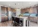 Modern kitchen with stainless steel appliances, a center island, and sleek cabinetry at 7410 S Old Hammer Way, Aurora, CO 80016