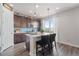 Stylish kitchen with a center island, pendant lighting, and views of the backyard at 7410 S Old Hammer Way, Aurora, CO 80016
