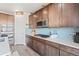 Modern kitchen featuring stainless steel appliances, blue backsplash, and hardwood floors at 7410 S Old Hammer Way, Aurora, CO 80016