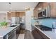 Well-equipped kitchen with stainless steel appliances, gas range, and ample counter space at 7410 S Old Hammer Way, Aurora, CO 80016