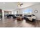 Open-concept living area with hardwood floors, a large window, and a glimpse of the kitchen at 7410 S Old Hammer Way, Aurora, CO 80016
