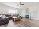 Spacious living room with hardwood floors, a fireplace, and lots of natural light at 7410 S Old Hammer Way, Aurora, CO 80016