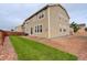 Exterior backyard with a grassy lawn, rock features, and a wooden fence at 13351 Olive Way, Thornton, CO 80602