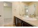 Well-lit bathroom featuring a double vanity, toilet, and large shower with glass door at 13351 Olive Way, Thornton, CO 80602