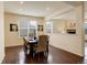 Elegant dining room featuring hardwood floors, neutral walls, recessed lighting, and an open view into the living room at 13351 Olive Way, Thornton, CO 80602
