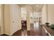 Inviting entryway with hardwood floors leading to open-concept living and dining areas with lots of natural light at 13351 Olive Way, Thornton, CO 80602