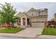 Charming two-story home with stone accents, solar panels, well-maintained lawn, and an attached two-car garage at 13351 Olive Way, Thornton, CO 80602