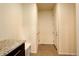 Bright hallway with neutral walls, tiled floor, and a granite-topped sideboard at 13351 Olive Way, Thornton, CO 80602