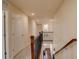 Hallway features hardwood stairs, carpeted hallway, and doors to various rooms at 13351 Olive Way, Thornton, CO 80602