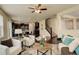Open-concept living room and kitchen area with modern decor, hardwood floors, and plenty of natural light at 13351 Olive Way, Thornton, CO 80602