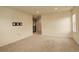 Spacious living room with neutral carpet, a TV mount, and plenty of natural light at 13351 Olive Way, Thornton, CO 80602