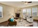 Comfortable living room featuring a stone fireplace, hardwood floors, neutral walls, and ceiling fan at 13351 Olive Way, Thornton, CO 80602