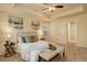 Cozy main bedroom boasts a tray ceiling, fan, two side tables, and a queen-sized bed with throw pillows at 13351 Olive Way, Thornton, CO 80602