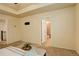 Spacious main bedroom has a tray ceiling, carpet, and an open doorway leading to an en suite bathroom at 13351 Olive Way, Thornton, CO 80602