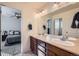 Double vanity bathroom with a view into a bedroom, and updated cabinetry at 5583 S Elk Ct, Aurora, CO 80016