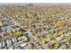 Expansive aerial view showcasing a dense neighborhood with mature trees and a distant city skyline at 601 Jackson St, Denver, CO 80206