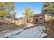 Spacious backyard with wooden fence in partially snowy weather at 601 Jackson St, Denver, CO 80206