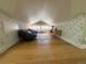 Attic bedroom featuring floral wallpaper and wood floors at 601 Jackson St, Denver, CO 80206