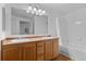 Bathroom featuring double sinks, wood cabinets, and a shower-tub combination at 7440 S Blackhawk St # 104, Englewood, CO 80112