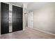 Bedroom with large mirrored closet and access to additional room, offering ample space at 7440 S Blackhawk St # 104, Englewood, CO 80112