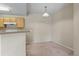 Dining area showcases an overhead light fixture and opens up to the kitchen at 7440 S Blackhawk St # 104, Englewood, CO 80112