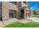 Stone condominium building exterior showcasing architectural details and covered stairwell at 7440 S Blackhawk St # 104, Englewood, CO 80112