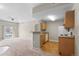 The living room opens to the kitchen, which includes wooden cabinets and an open breakfast bar at 7440 S Blackhawk St # 104, Englewood, CO 80112