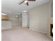 Open-concept living space featuring neutral walls, carpet, and views of the kitchen area at 7440 S Blackhawk St # 104, Englewood, CO 80112