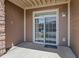 Covered patio area with sliding glass door and exterior access at 7440 S Blackhawk St # 104, Englewood, CO 80112