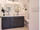 Stylish bathroom featuring a double vanity with modern fixtures and ample lighting at 9557 Pearl Cir # 204, Parker, CO 80134