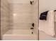 Tiled shower and bathtub combination with modern fixtures and hardware at 9557 Pearl Cir # 204, Parker, CO 80134