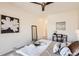Relaxing bedroom features a ceiling fan, a desk, a large bed, and neutral colors at 9557 Pearl Cir # 204, Parker, CO 80134