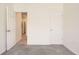 Bedroom featuring carpet, neutral paint, and doors to other areas of the home at 9557 Pearl Cir # 204, Parker, CO 80134
