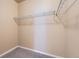 Walk-in closet with shelving and neutral carpeting for organized storage at 9557 Pearl Cir # 204, Parker, CO 80134