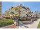 Inviting exterior view of townhomes, landscaped with stone retaining walls and well-maintained landscaping at 9557 Pearl Cir # 204, Parker, CO 80134