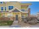 Charming two-story home featuring a welcoming front door, stone accents, and a lovely second story balcony at 9557 Pearl Cir # 204, Parker, CO 80134