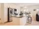 Modern kitchen featuring stainless steel appliances, granite countertops, and a large island with seating at 9557 Pearl Cir # 204, Parker, CO 80134