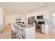 Bright and airy kitchen featuring a granite island, stainless steel appliances, and sleek white cabinetry at 9557 Pearl Cir # 204, Parker, CO 80134