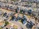 An aerial view of a residential neighborhood showcasing well-maintained homes and tree-lined streets at 758 Poppywood Pl, Highlands Ranch, CO 80126