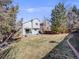 Large backyard featuring lush green grass, mature trees, and patio area at 758 Poppywood Pl, Highlands Ranch, CO 80126