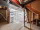 Unfinished basement featuring exposed framework, concrete floor, and framed opening to a finished room at 758 Poppywood Pl, Highlands Ranch, CO 80126