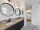 Elegant bathroom featuring double sinks, granite countertops, designer tile work, and a shower at 758 Poppywood Pl, Highlands Ranch, CO 80126