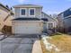 Charming two-story home featuring a gray exterior, brick accents, attached garage, and well-maintained lawn at 758 Poppywood Pl, Highlands Ranch, CO 80126