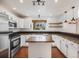 Modern kitchen featuring stainless steel appliances, dark backsplash, and a wooden island at 758 Poppywood Pl, Highlands Ranch, CO 80126