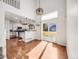 Open-concept living space showcasing hardwood floors, a staircase, and seamless flow to the kitchen at 758 Poppywood Pl, Highlands Ranch, CO 80126